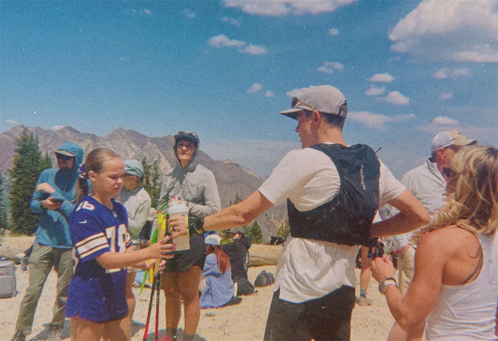 Man standing at the aid station of an ultramarthon in the mountains