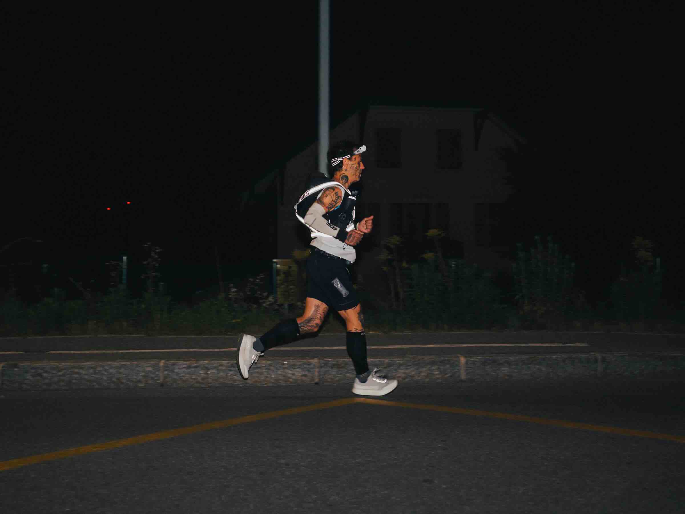 Runner in dark street at night