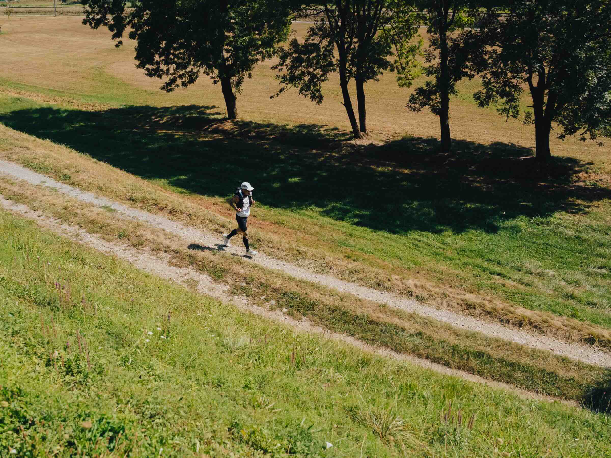 Person jogging along grassy path