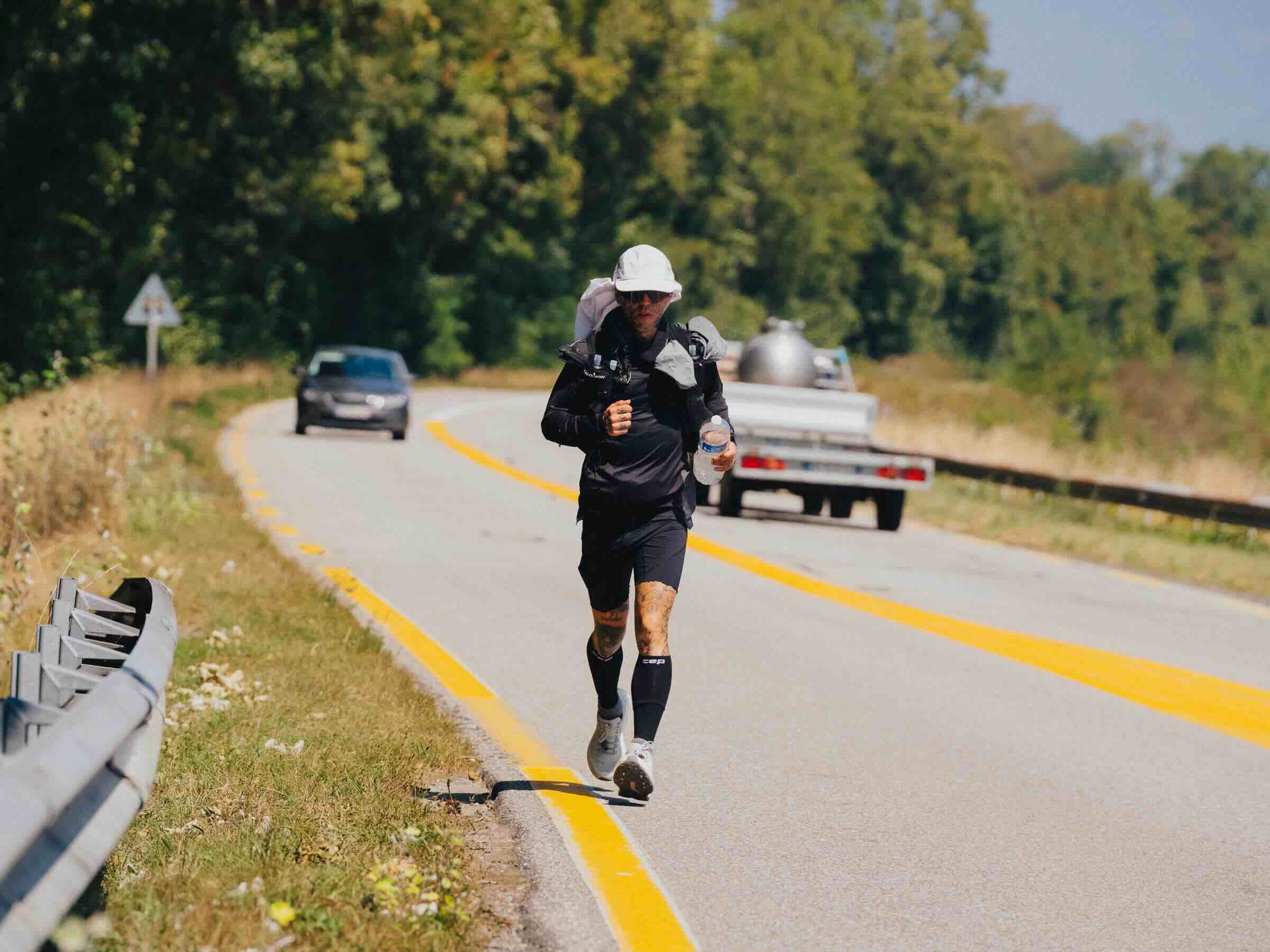 Runner on roadside near vehicles