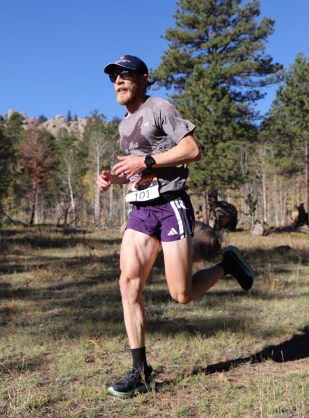 Clint Anders Runner Clint Anders in a forested landscape.
