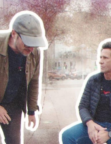 Two friends in a city setting.