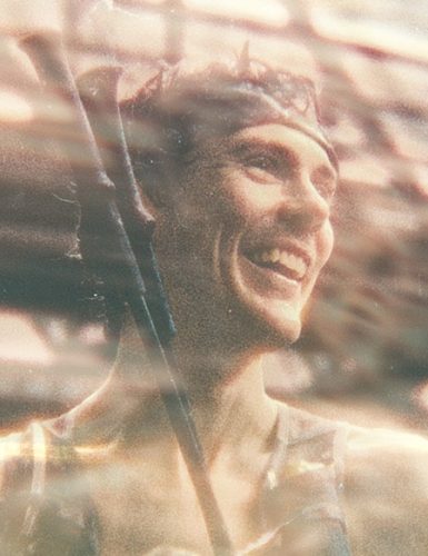 Person in a blurred urban setting. Scott Jurek.