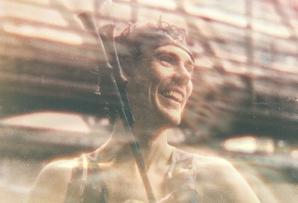 Person in a blurred urban setting. Scott Jurek.