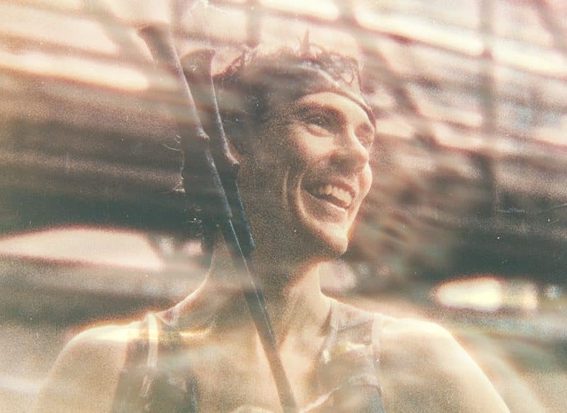 Person in a blurred urban setting. Scott Jurek.