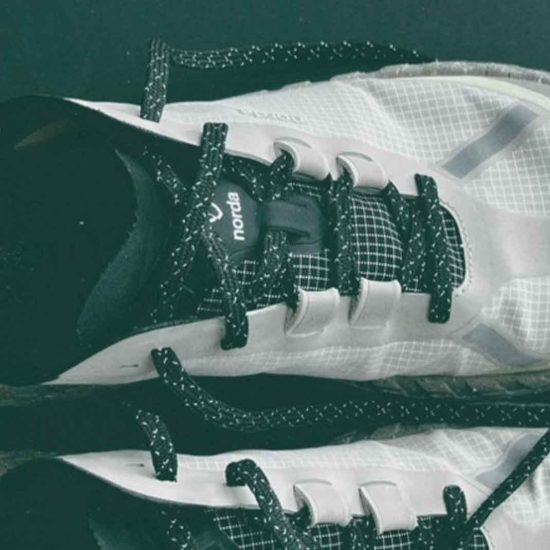 White athletic shoes with black laces - Norda 001a