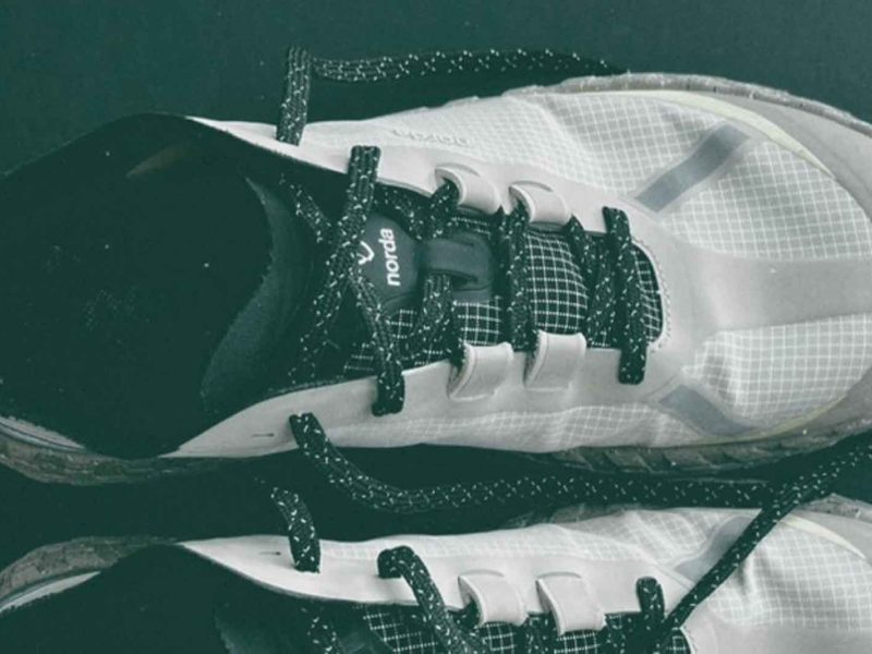 White athletic shoes with black laces - Norda 001a