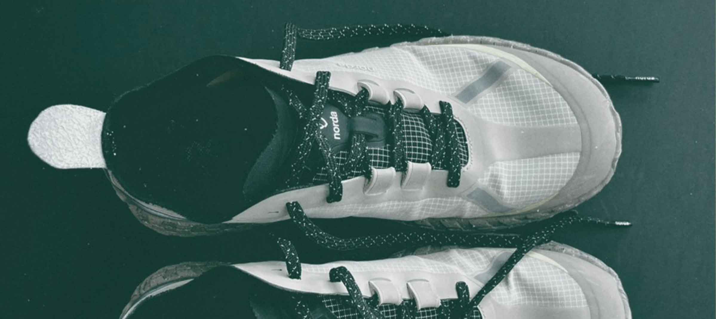 White athletic shoes with black laces - Norda 001a