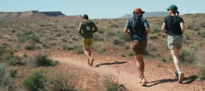 Runners on a desert trail. Luxury Running Brands.