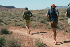 Runners on a desert trail. Luxury Running Brands.