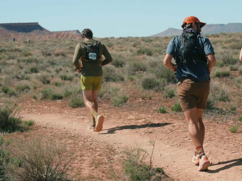 Runners on a desert trail. Luxury Running Brands.