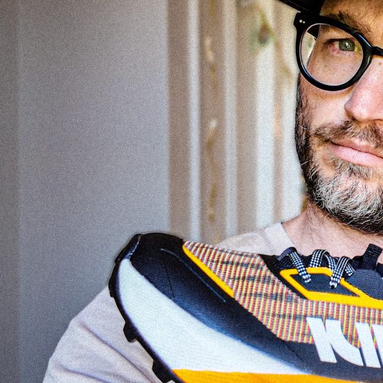 A beautiful man holding a kiprun shoe