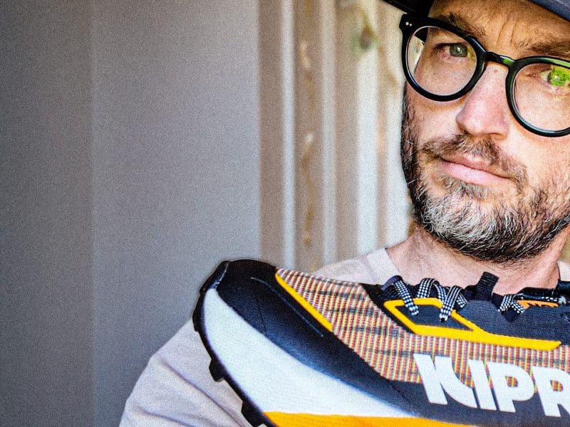 A beautiful man holding a kiprun shoe