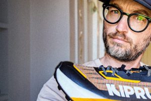 A beautiful man holding a kiprun shoe