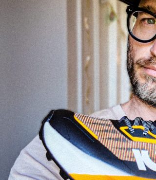 A beautiful man holding a kiprun shoe