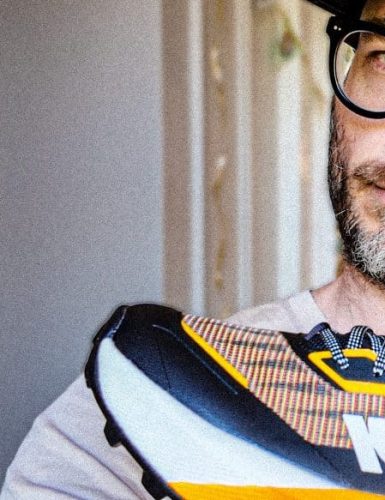 A beautiful man holding a kiprun shoe