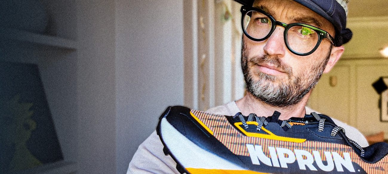 A beautiful man holding a kiprun shoe