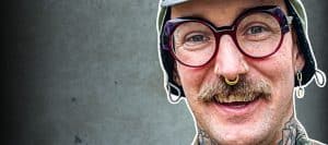 Smiling person with glasses and tattoos - Mike Kratzer