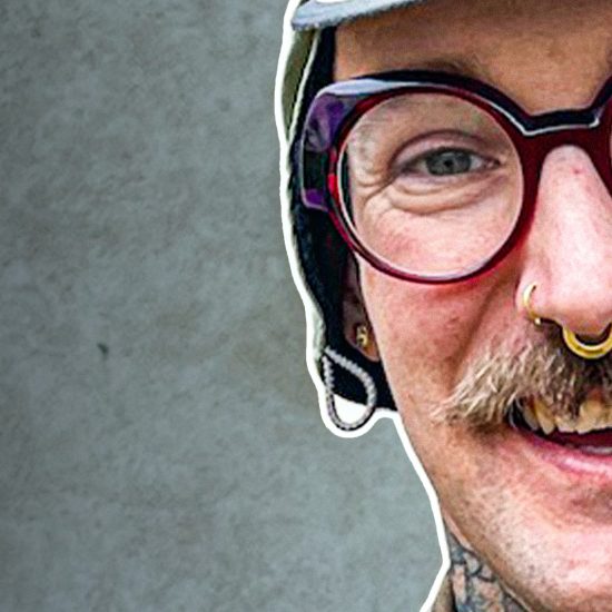 Smiling person with glasses and tattoos - Mike Kratzer