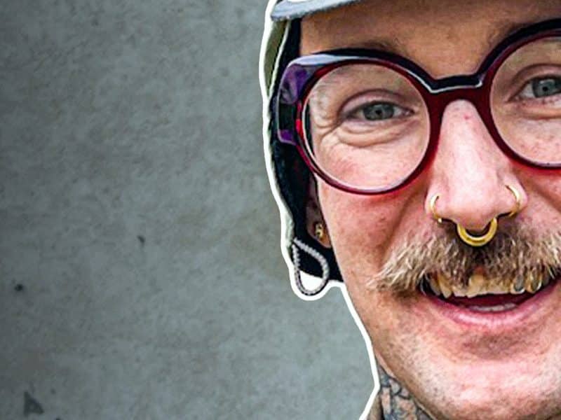 Smiling person with glasses and tattoos - Mike Kratzer