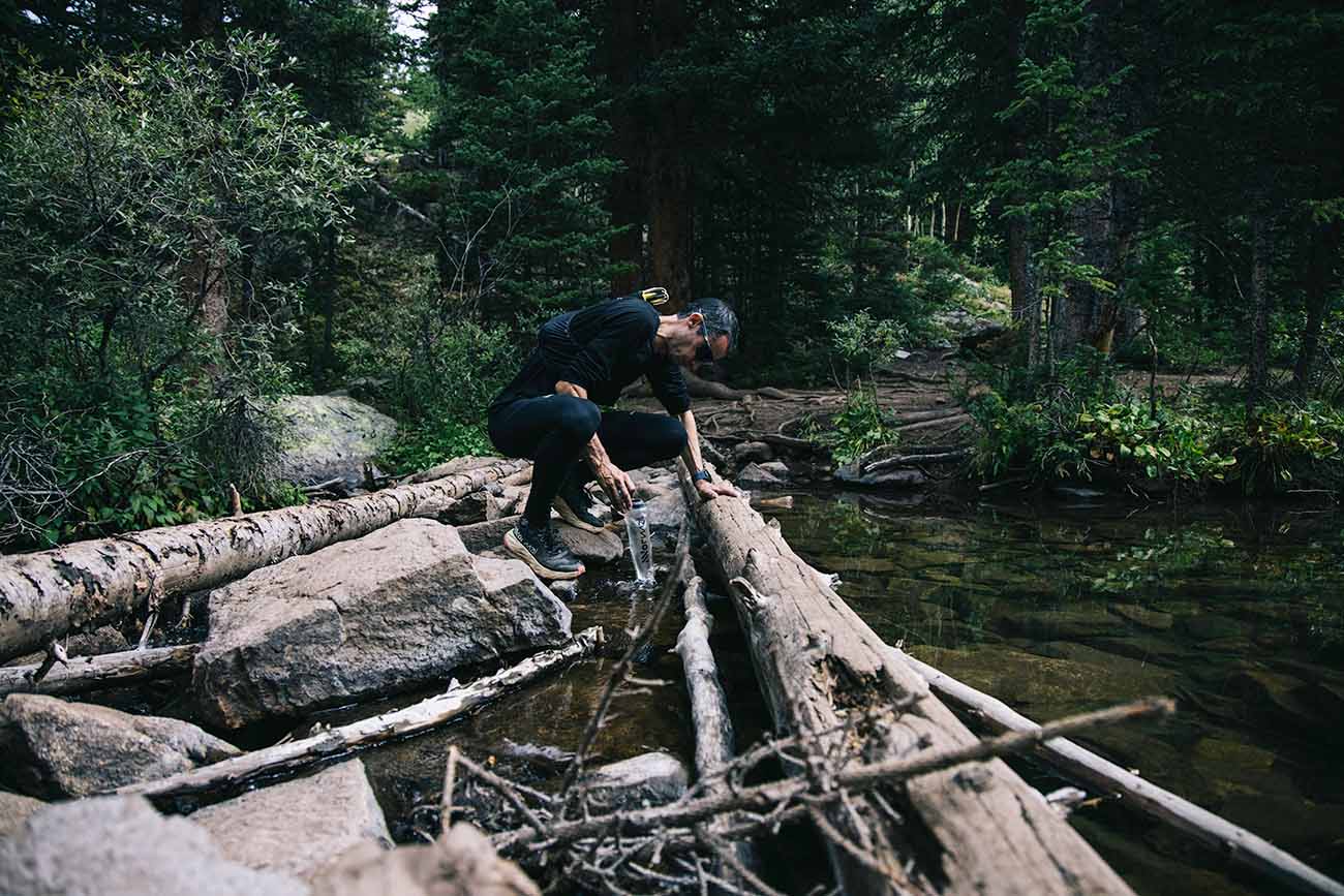 Kilian Jornet - Andy Cochrane Runner stopping at a river for a drink