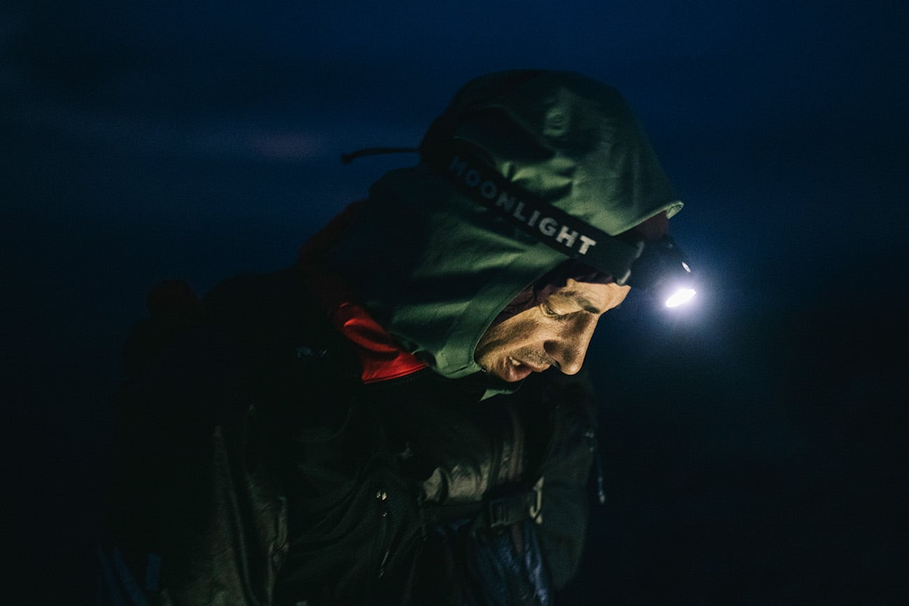 Kilian Jornet - Andy Cochrane Runner wearing headlight preparing to run in the night