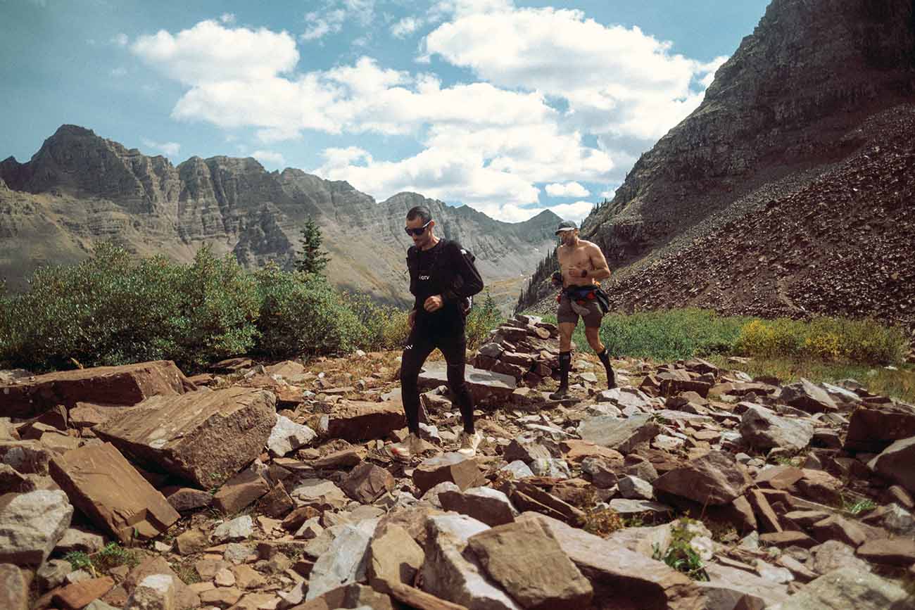 Kilian Jornet - Nick Danielson Two people running on rocky terrain in the mountains of Colorado