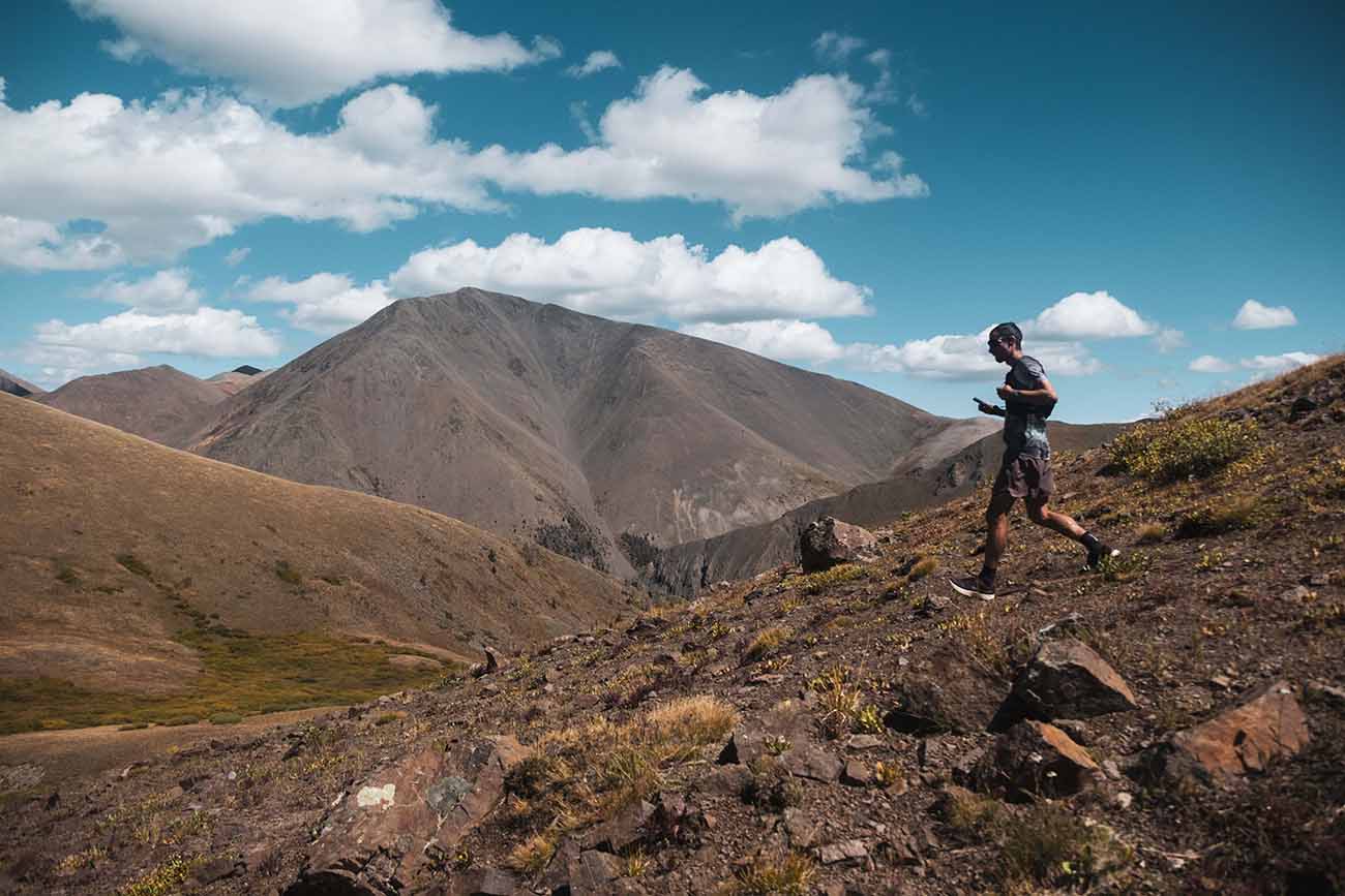 Kilian Jornet - Nick Danielson A man running down a mountain in Colorado