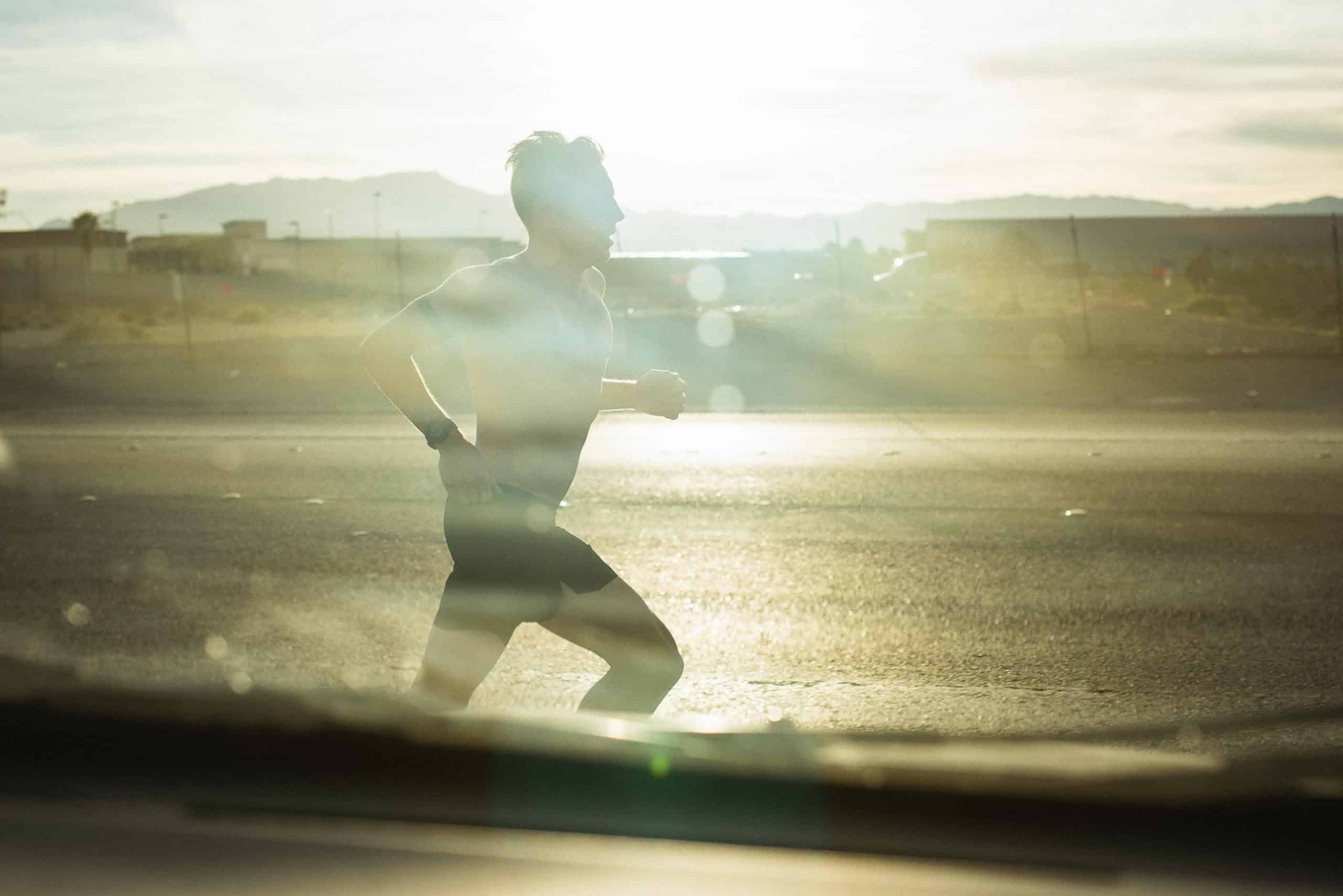 Nils Arend - Christian Brecheis for Borderlands Trail Running-4 Sillhouette of a runner in the setting sun.