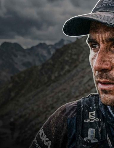 Determined athlete in rugged landscape.