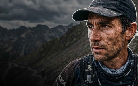 Determined athlete in rugged landscape.