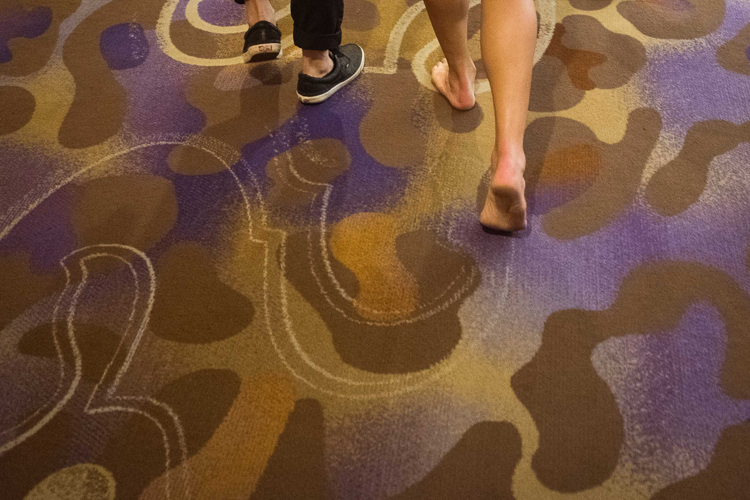 The Speed Project - Christian Brecheis - Borderlands Trail Running Two people walking along the Las Vegas floor, one without shoes