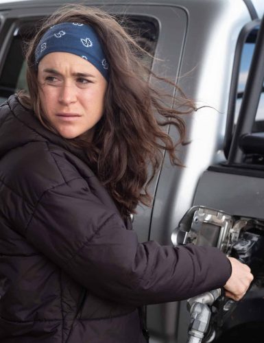 Molly Seidel fueling vehicle at gas station.