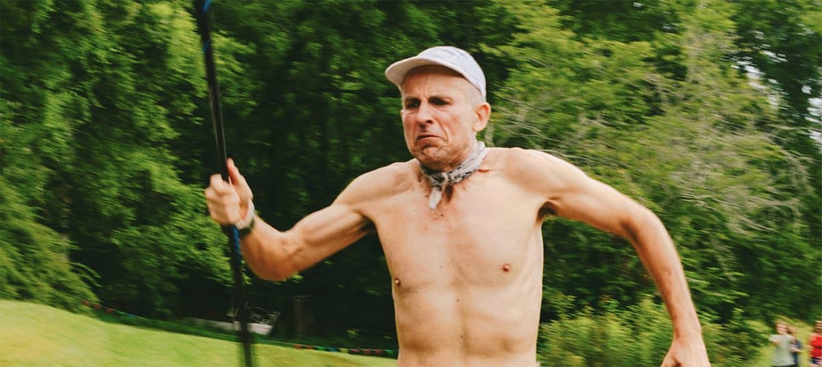 Shirtless runner Harvey Lewis in nature, intense expression