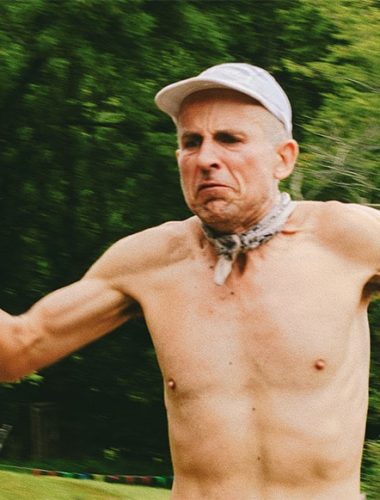 Shirtless runner Harvey Lewis in nature, intense expression
